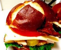 fresh BLT sandwich on a pretzel bun for lunch